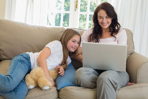 Mom at home with child getting education via distance education